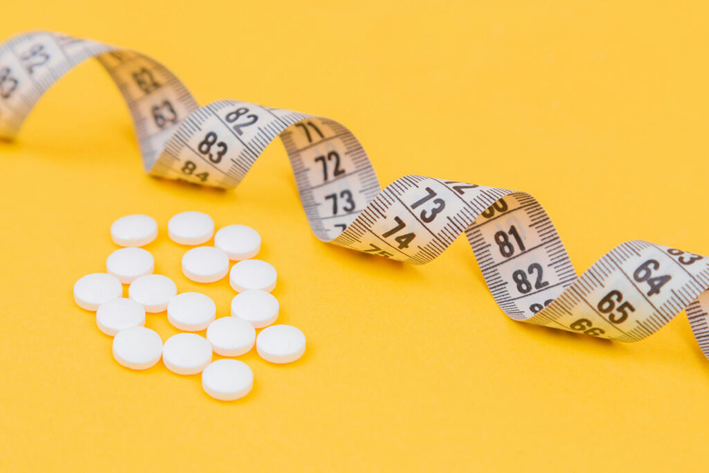 pills and tape measure